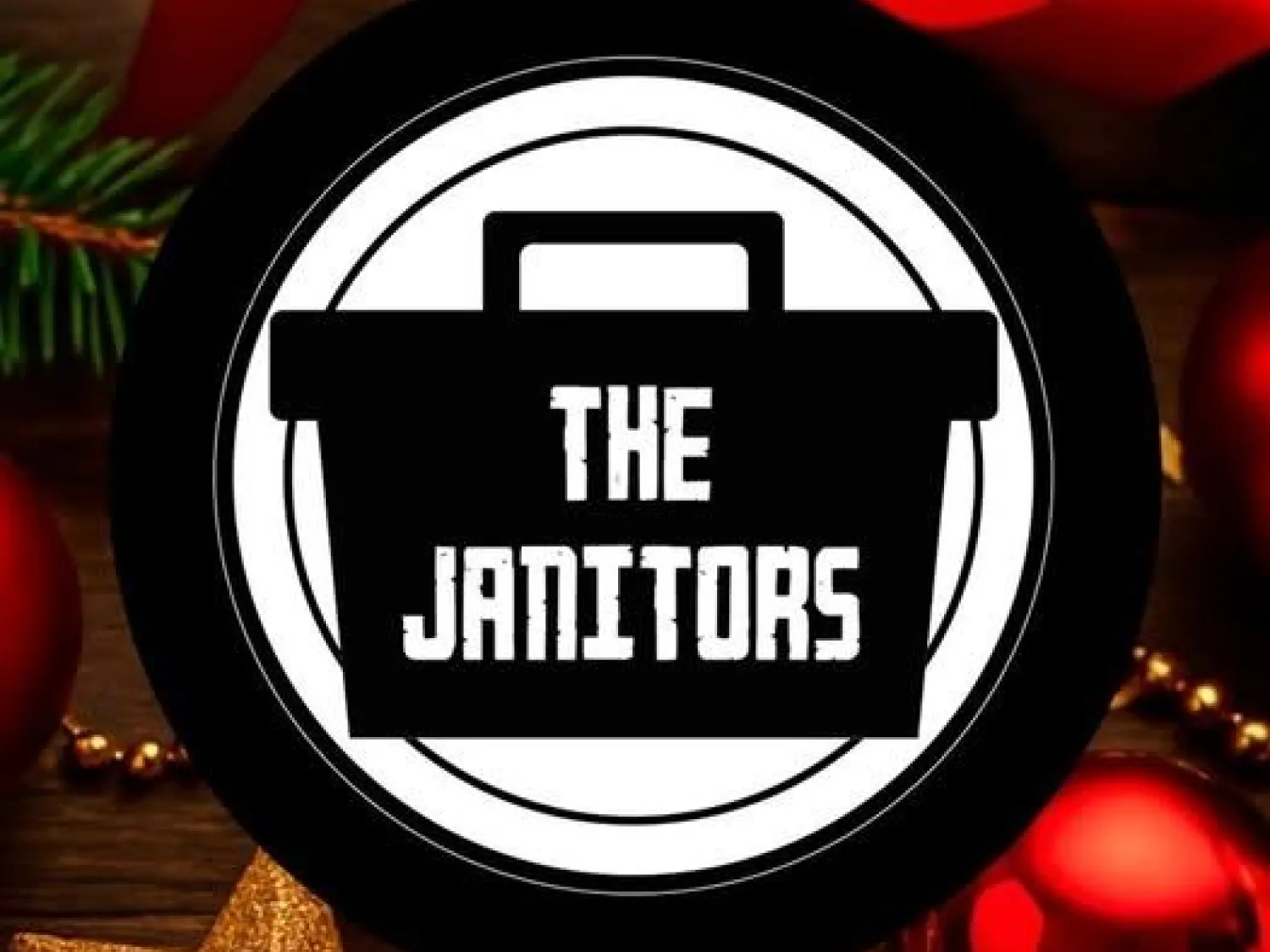Färgbild - juldekorationer i bakgrunden, och text ovanpå bilden: The Janitors.