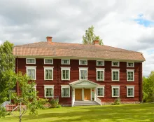 Jon-Lars i Långhed Färgbild - Hälsingegård Jon-Lars - exteriör bild på röd och vit husbyggnad